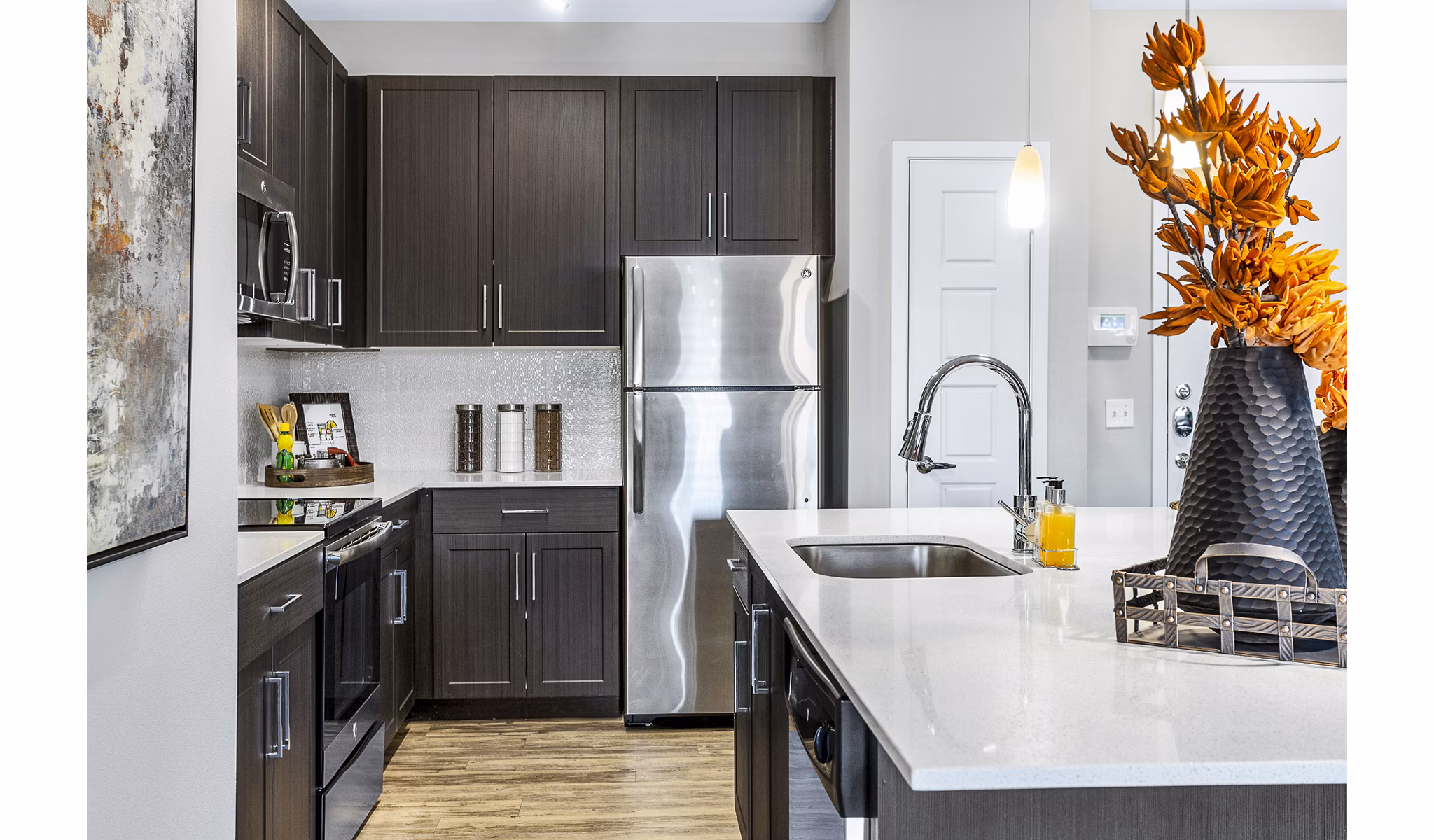 Modern kitchen with stainless steel appliances and quartz countertops at 601 PAX Apartments