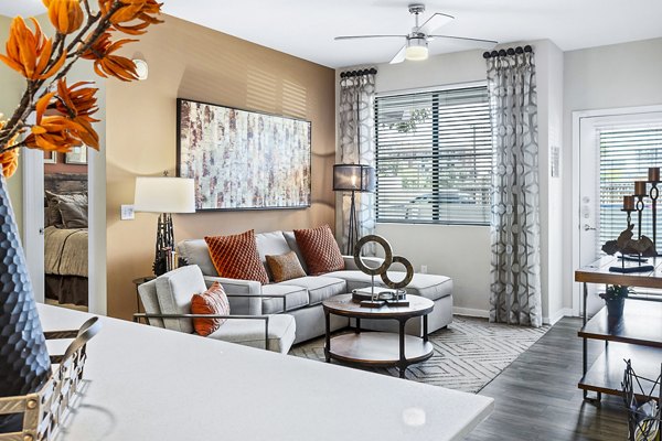 Spacious living room with modern furnishings at 601 PAX Apartments, offering luxury apartment living in vibrant city surroundings