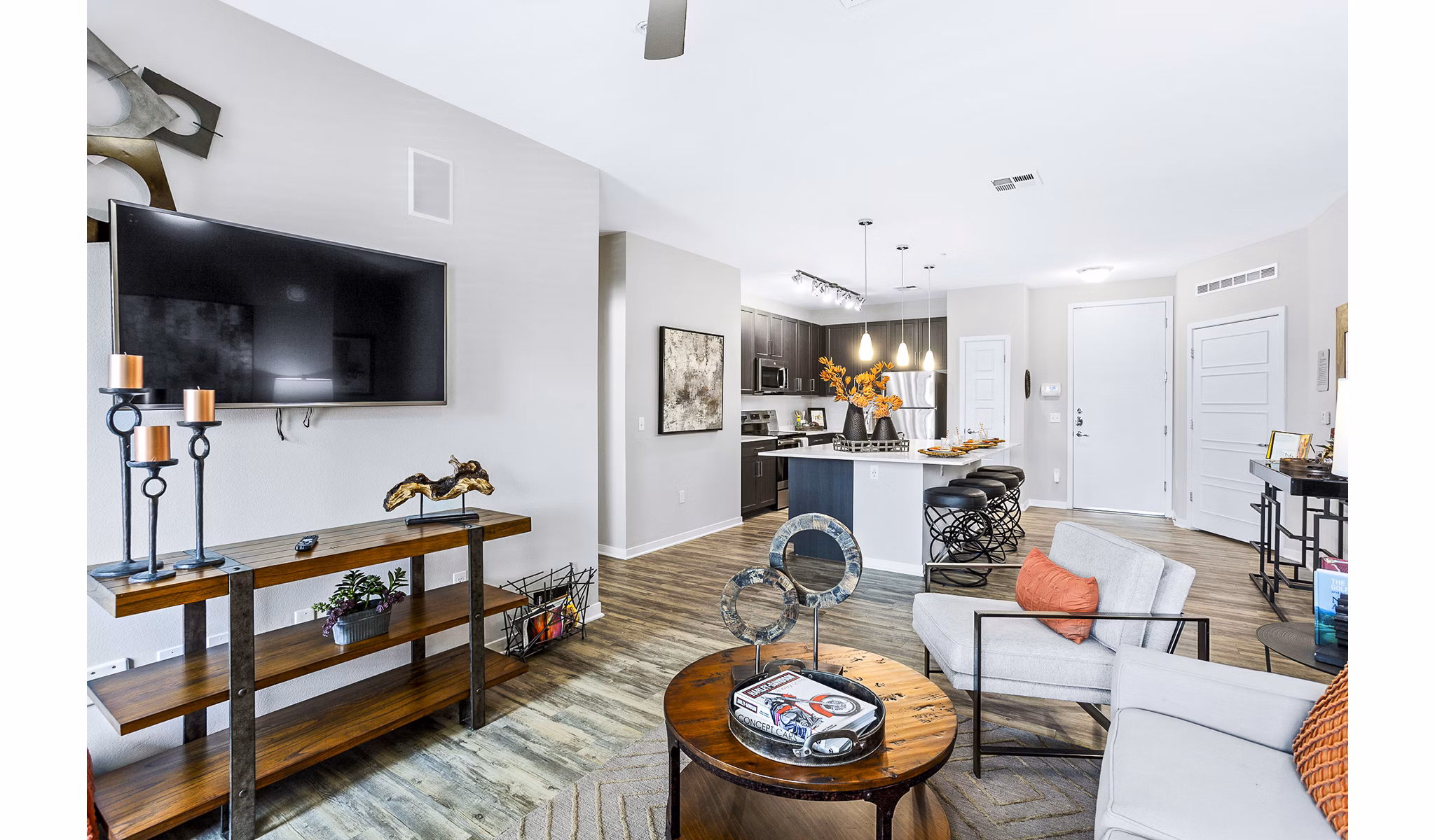 Spacious living room with modern furnishings and large windows at 601 PAX Apartments, a Greystar luxury property in urban setting