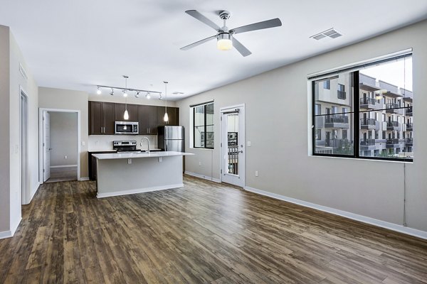 Living room featuring modern decor and natural light at 601 PAX Apartments, a luxury Greystar property