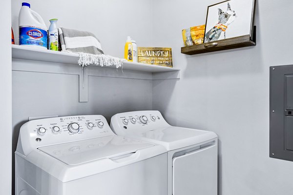 Laundry room featuring modern washers and dryers at 601 PAX Apartments, a Greystar luxury residence