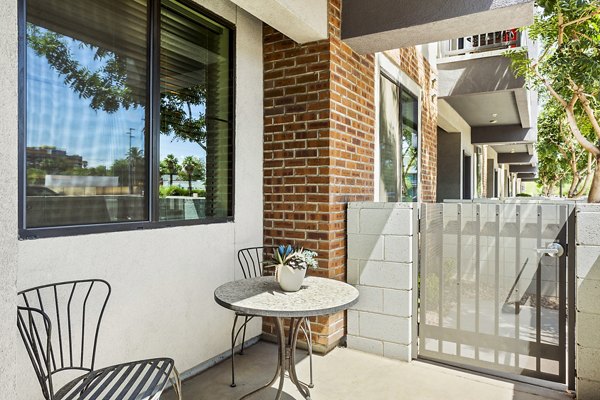 Cozy patio with modern furniture at 601 PAX Apartments overlooking the city skyline