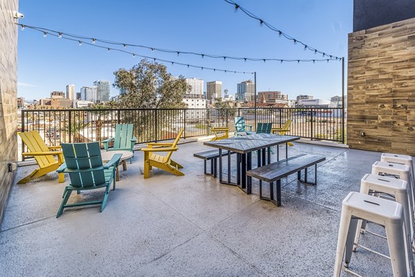 Outdoor patio with modern seating at 601 PAX Apartments clubhouse, ideal for relaxing and socializing in a luxury setting