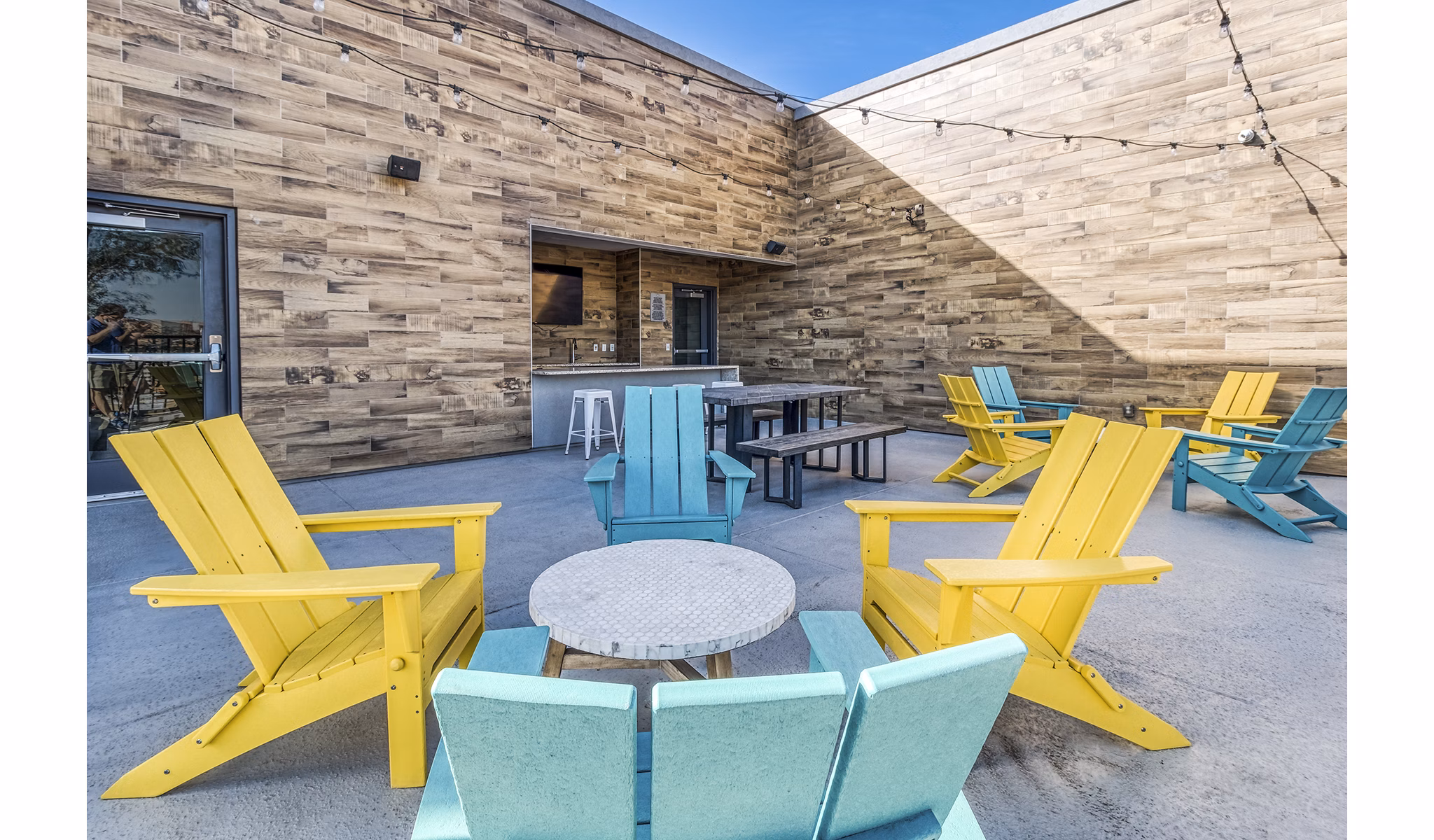 Outdoor clubhouse patio with stylish seating and city views at 601 PAX Apartments