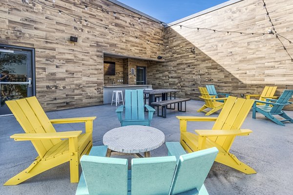Outdoor clubhouse patio with stylish seating and city views at 601 PAX Apartments