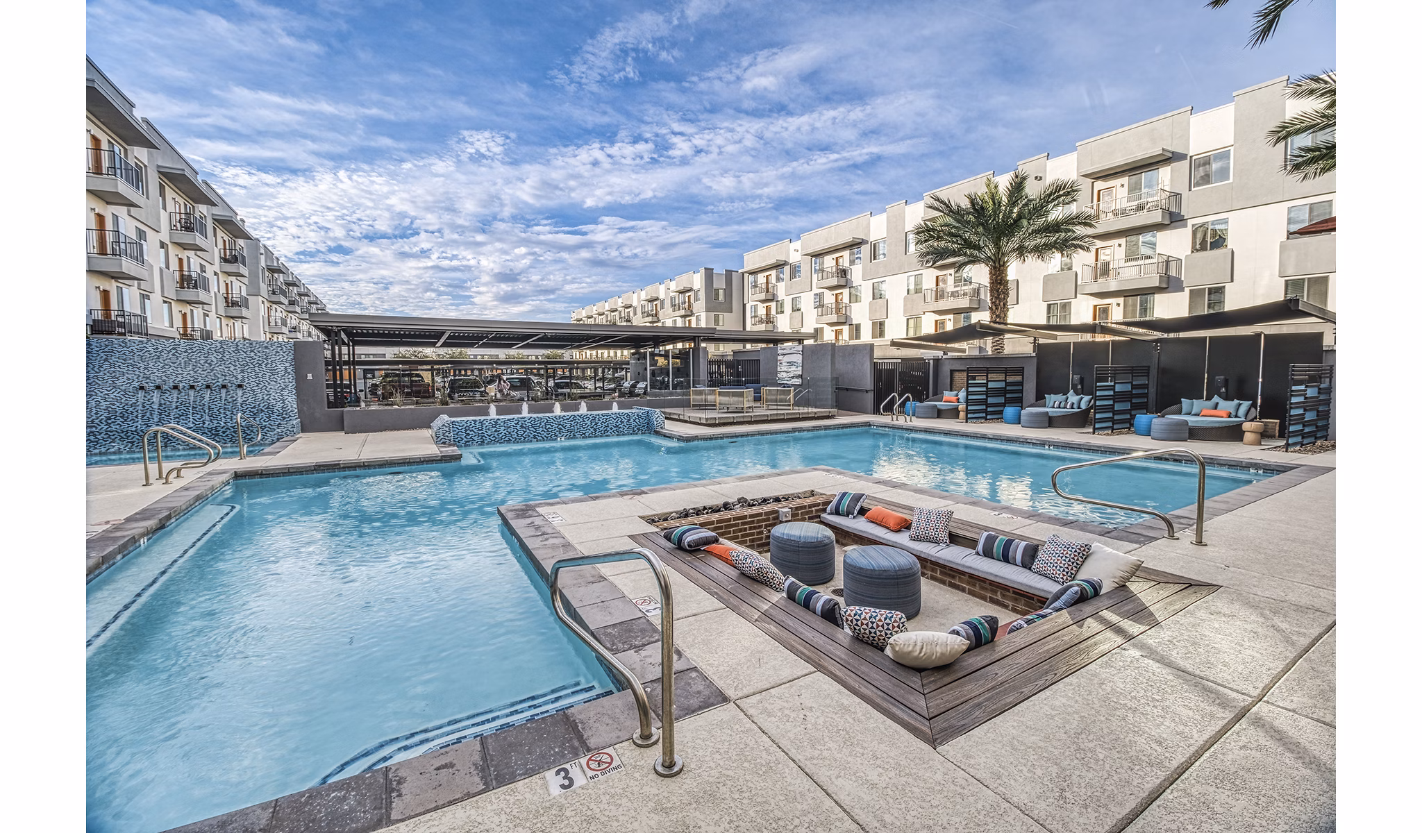 Elegant nighttime view of a sparkling pool at 601 PAX Apartments, offering a luxurious retreat in a premier urban location