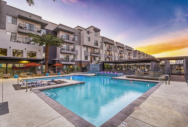 Inviting pool area with sun loungers at 601 PAX Apartments, a luxury Greystar community