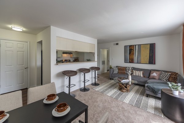Living room features modern decor and ample natural light in Avana Fieldstone Apartments
