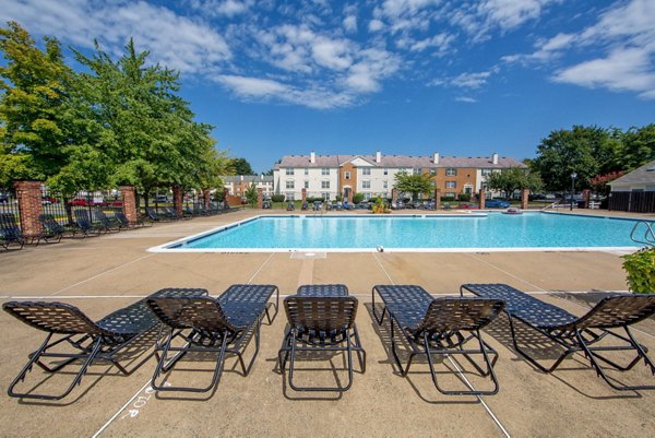 Relaxing poolside oasis with lounge chairs at Avana Fieldstone Apartments