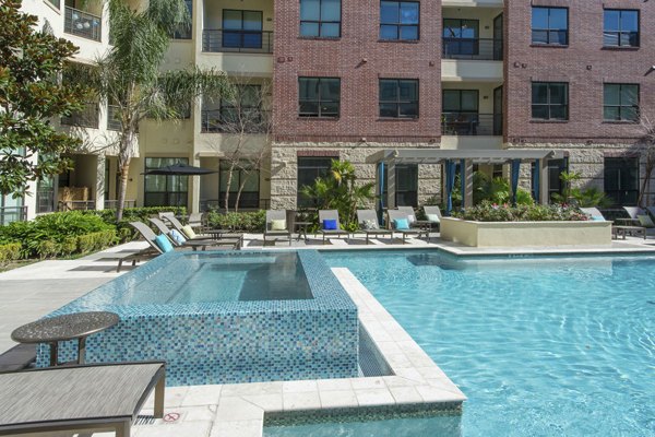 Rooftop pool with city views at Millennium High Street Apartments