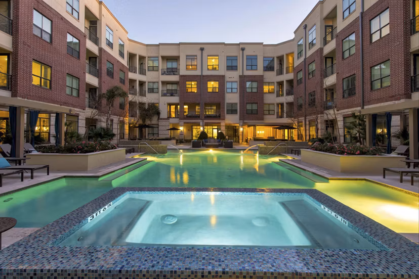 Pool with contemporary design at Millennium High Street Apartments with lush greenery, providing a luxury resort-like experience for residents