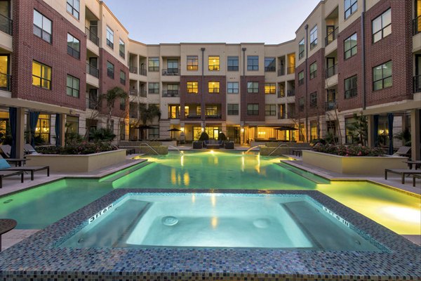 Pool with contemporary design at Millennium High Street Apartments with lush greenery, providing a luxury resort-like experience for residents