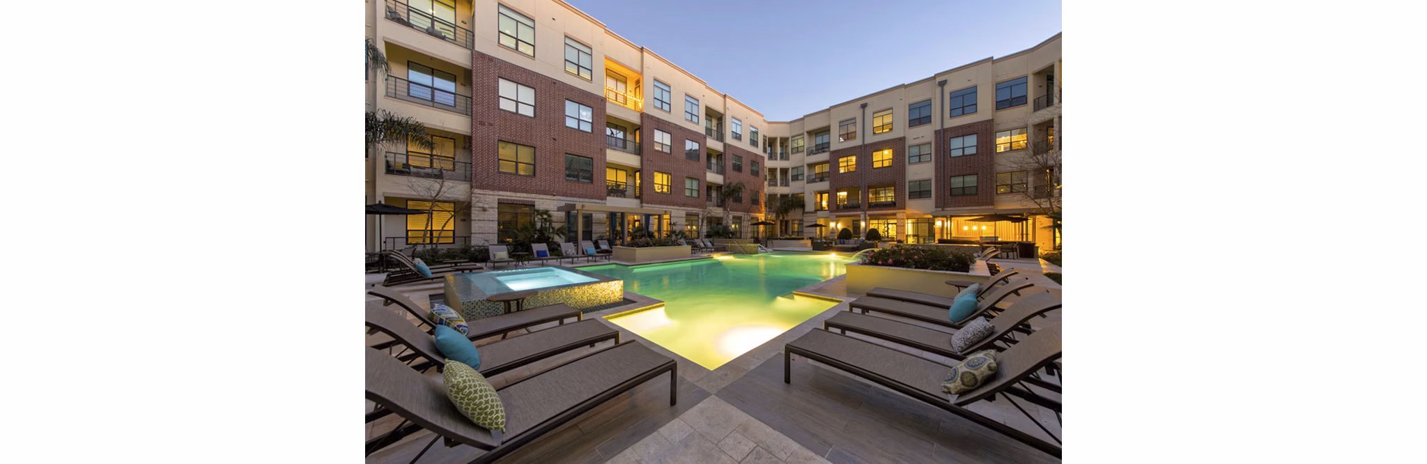 Sun-drenched pool with stylish lounge chairs at Millennium High Street Apartments offering luxury living