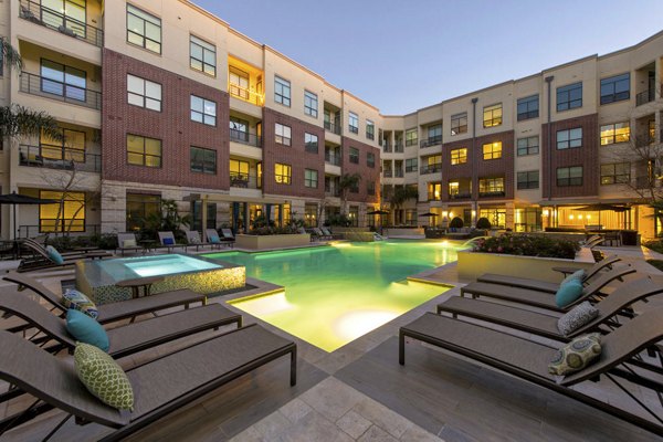 Sun-drenched pool with stylish lounge chairs at Millennium High Street Apartments offering luxury living