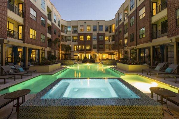 Rooftop pool with lounging area at Millennium High Street Apartments - luxury living in an urban oasis