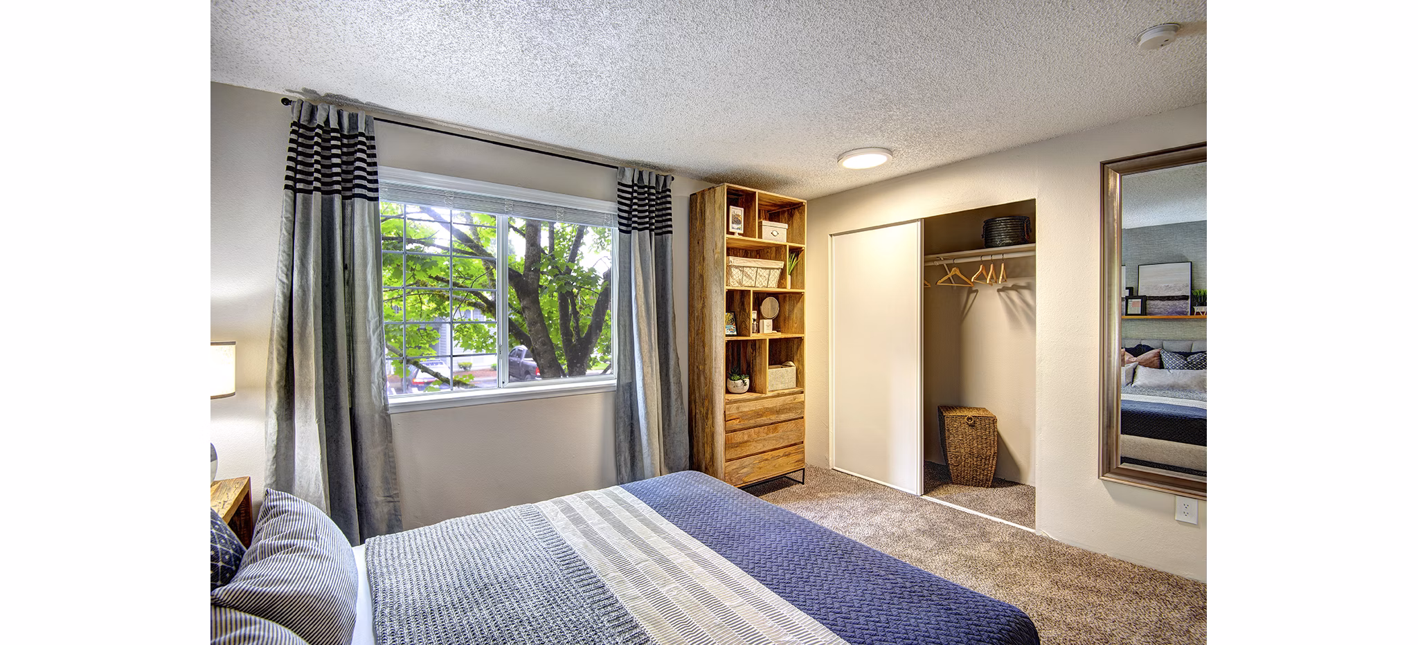 Modern bedroom with cozy decor at The Becket Apartments