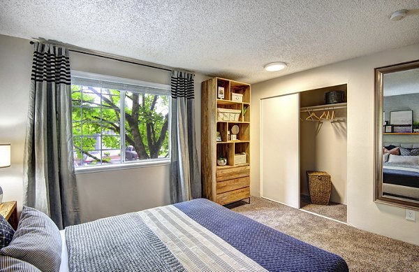 Modern bedroom with cozy decor at The Becket Apartments