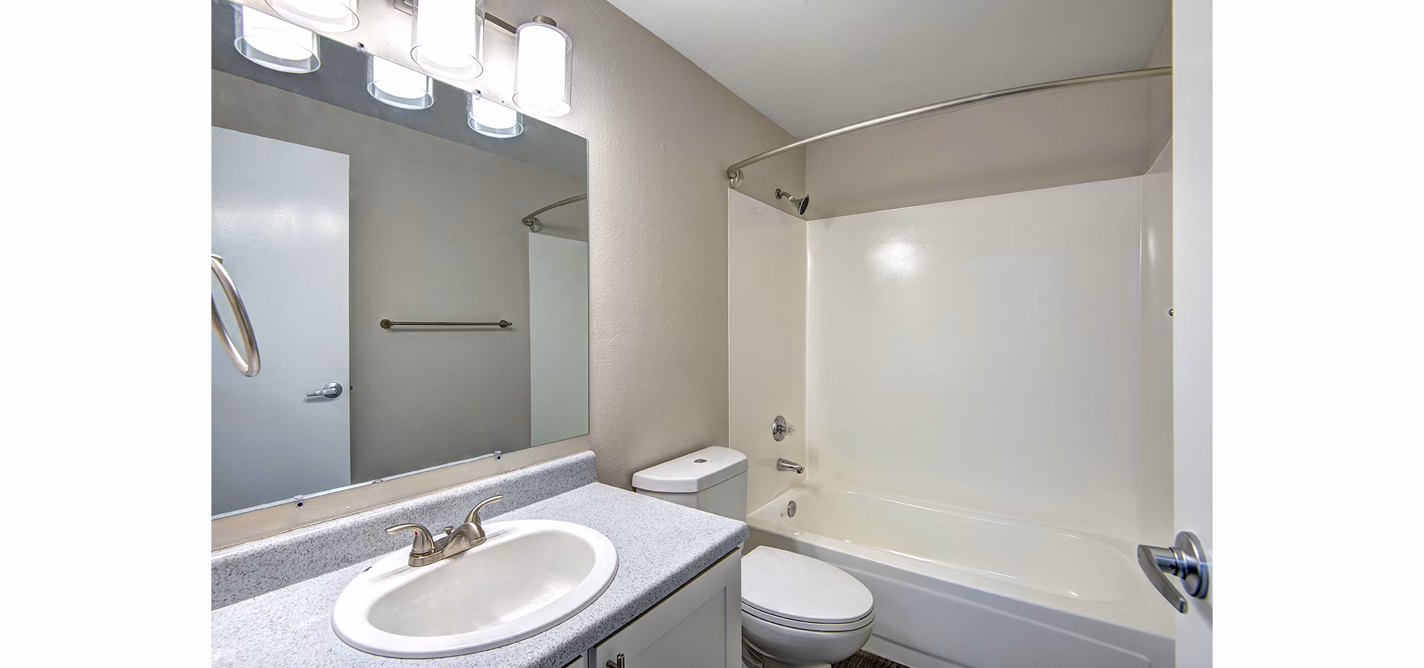 Luxurious bathroom with a modern vanity and glass shower at The Becket Apartments