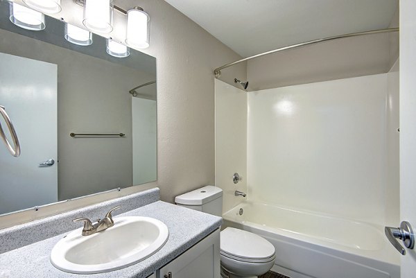 Luxurious bathroom with a modern vanity and glass shower at The Becket Apartments