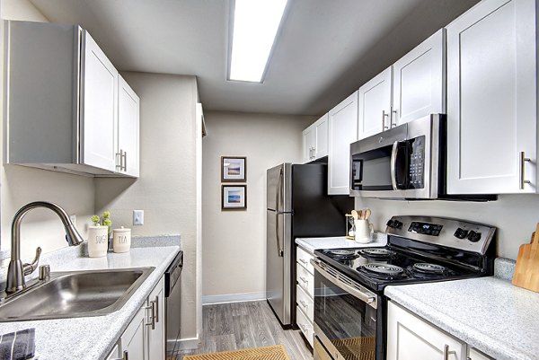 Modern kitchen with stainless steel appliances at The Becket Apartments