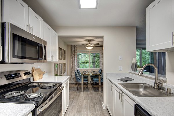 Contemporary kitchen with stainless steel appliances in The Becket Apartments