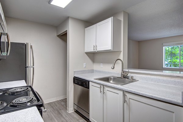 Modern kitchen with sleek countertops and stainless steel appliances at The Becket Apartments