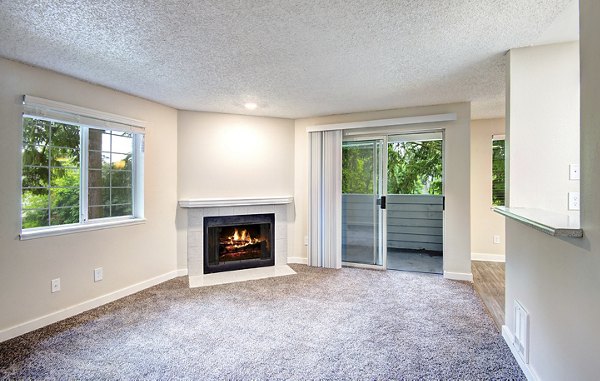 Spacious living room with modern decor in The Becket Apartments