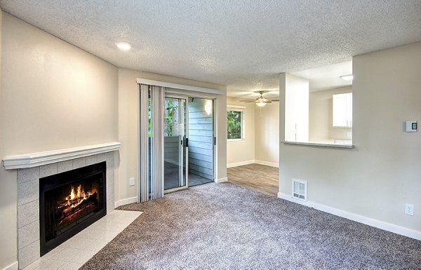 Modern living room with sleek furnishings and natural light at The Becket Apartments