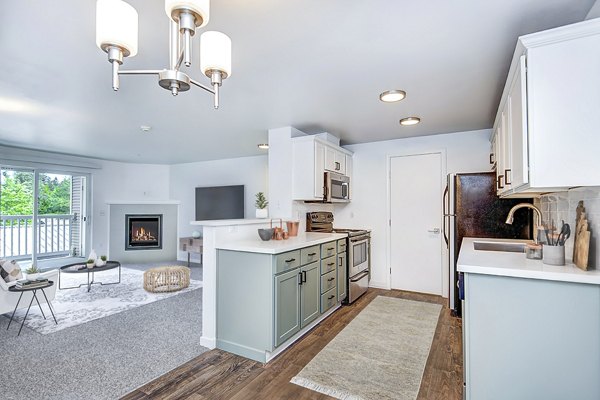 Contemporary kitchen with stainless-steel appliances and sleek cabinetry at Smyth Apartments