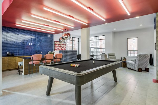 Modern game room featuring pool table and lounge seating at Encore Panther Island Apartments, luxury living in Fort Worth