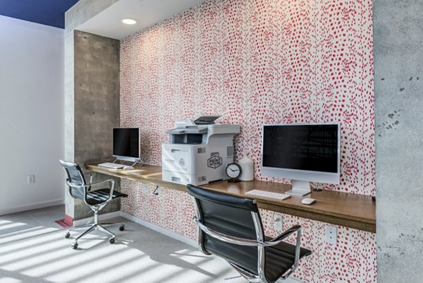 Modern business center with sleek workstations at Encore Panther Island Apartments