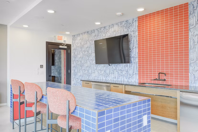 Clubhouse featuring modern decor and vibrant seating at Encore Panther Island Apartments