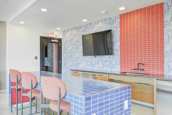 Clubhouse featuring modern decor and vibrant seating at Encore Panther Island Apartments
