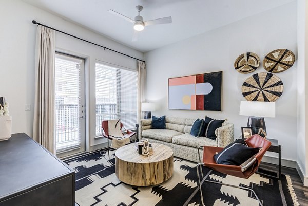 Modern living room with sleek furnishings and ample natural light at Encore Panther Island Apartments, offering luxury accommodations