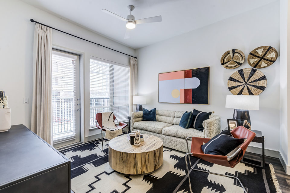 Modern living room with sleek furnishings and ample natural light at Encore Panther Island Apartments, offering luxury accommodations