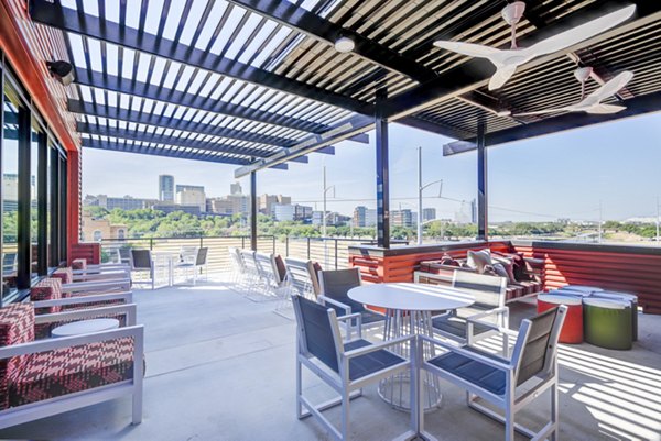 Rooftop deck with lounge seating and city views at Encore Panther Island Apartments