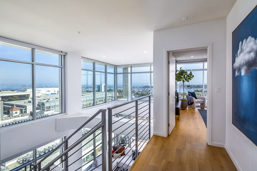 Elegant stairway leading to a modern bedroom at 200 West Ocean Apartments, showcasing luxury living spaces in an ideal coastal location