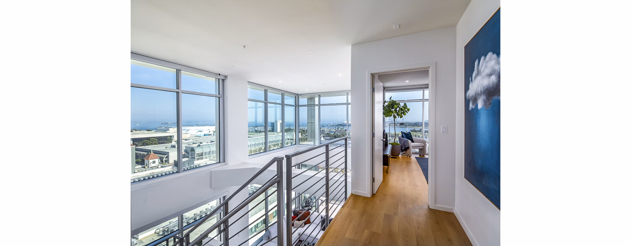 Elegant stairway leading to a modern bedroom at 200 West Ocean Apartments, showcasing luxury living spaces in an ideal coastal location