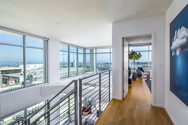 Elegant stairway leading to a modern bedroom at 200 West Ocean Apartments, showcasing luxury living spaces in an ideal coastal location