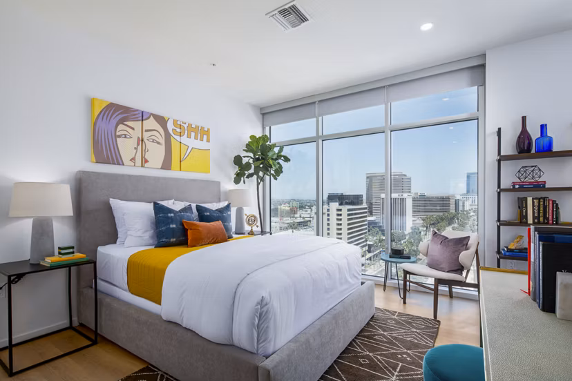 Elegant bedroom featuring ocean views and modern furnishings at 200 West Ocean Apartments