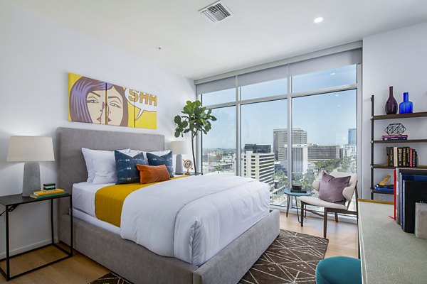 Elegant bedroom featuring ocean views and modern furnishings at 200 West Ocean Apartments