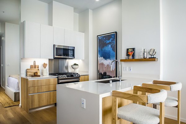 Modern kitchen with sleek cabinetry and stainless steel appliances at 200 West Ocean Apartments, a Greystar luxury residence