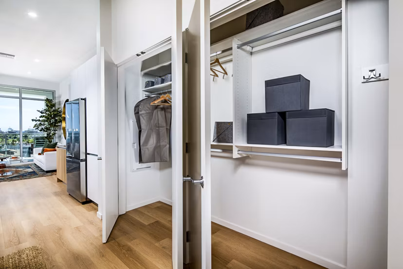 Entryway closet with organized shelving at 200 West Ocean Apartments