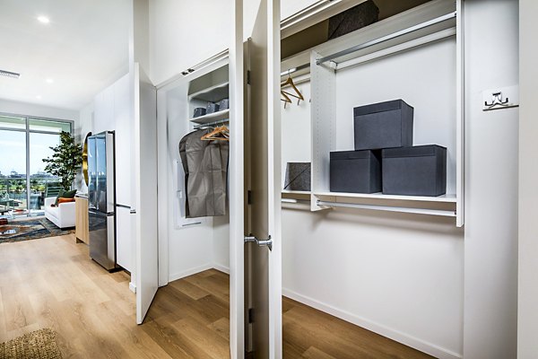 Entryway closet with organized shelving at 200 West Ocean Apartments