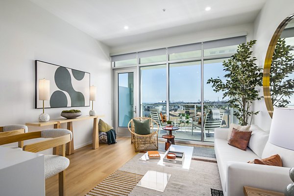 Spacious living room with ocean views in 200 West Ocean Apartments featuring luxury design elements
