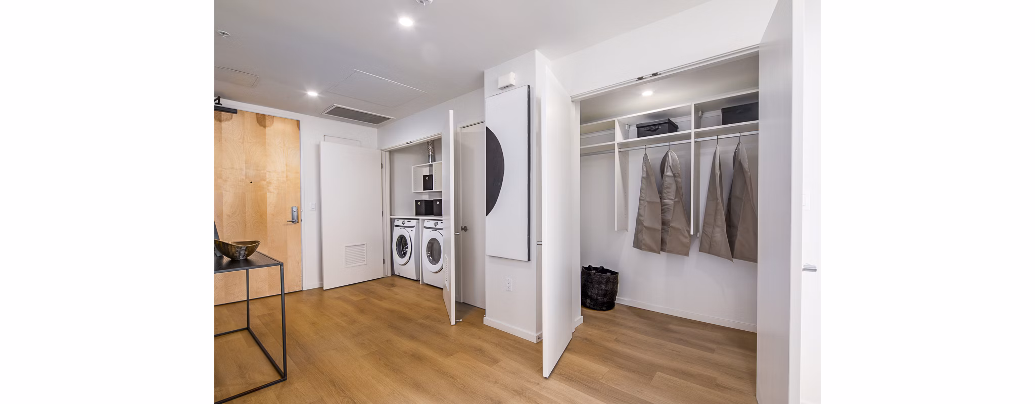 Laundry area with stacked washer and dryer in hallway closet at 200 West Ocean luxury apartments