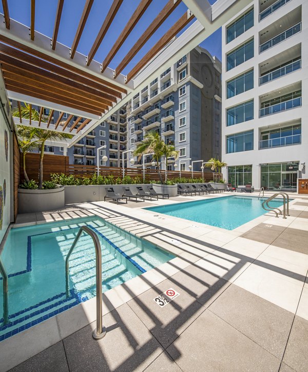 Modern outdoor pool with lounge chairs at 200 West Ocean Apartments, offering luxury amenities in a serene setting