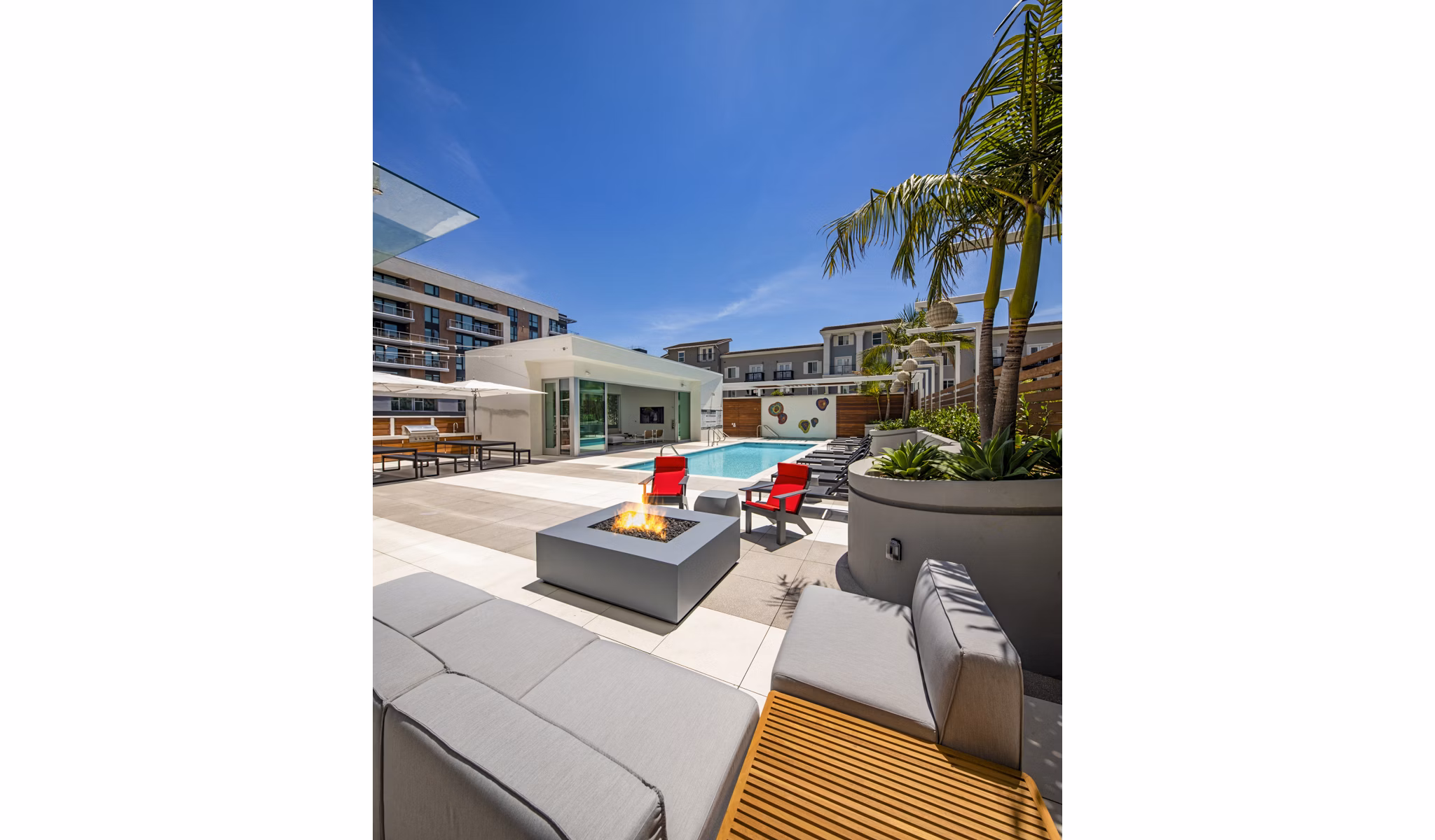 Inviting fire pit and pool area at 200 West Ocean Apartments