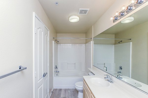 Modern bathroom featuring sleek fixtures at Waterford Place Apartments, highlighting luxury living and contemporary design