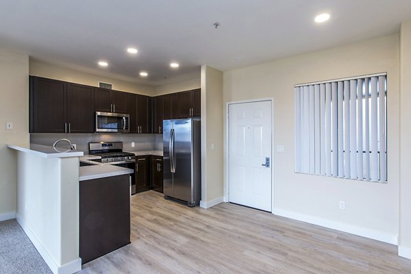 Dining room with elegant lighting and modern furniture at Waterford Place Apartments, luxury living by Greystar